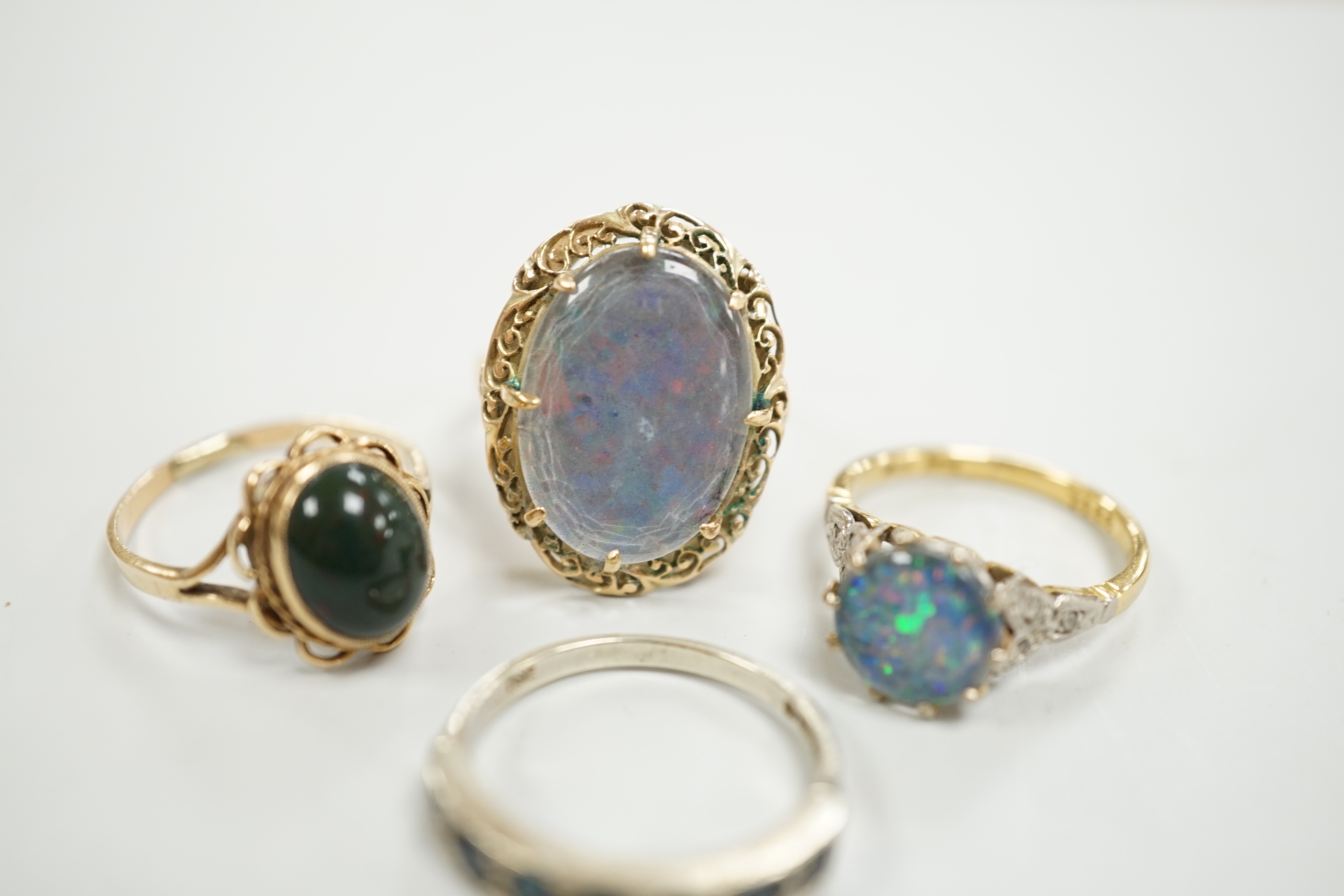 A 1940's 18ct and black opal doublet set dress ring, with diamond chip set shoulders, size L, a 14c and oval doublet ring and two other 9ct and gem set rings.
